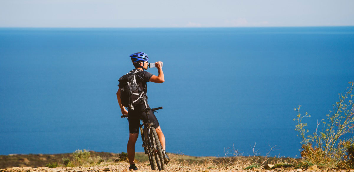 Moutain biker on the sea shore during his cycling holiday in Spain and the Costa Blanca 